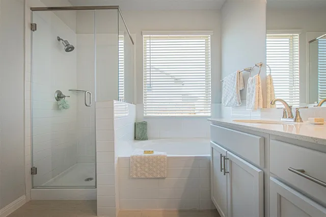 a bathroom with a tub sink and window