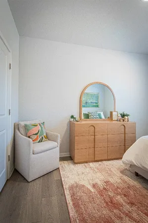 a bedroom with a bed and a dresser
