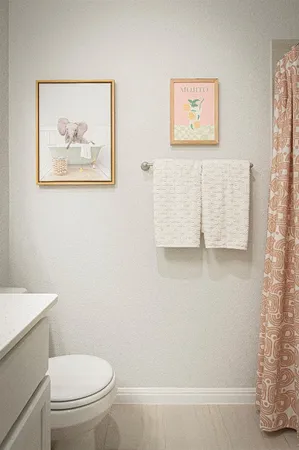 a white toilet sitting next to a white wall