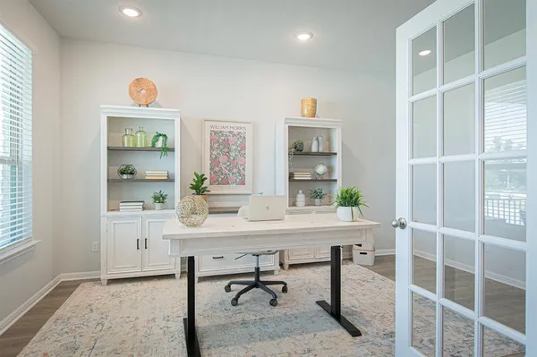 a view of a workspace with furniture and a window
