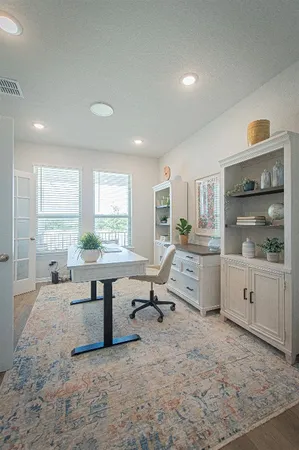 a living room with furniture a window and work place