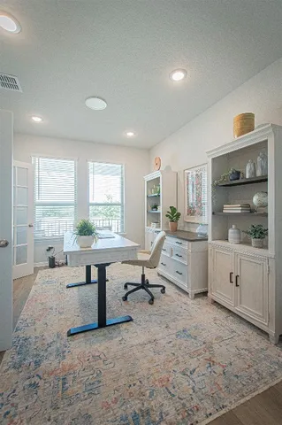 a living room with furniture a window and work place