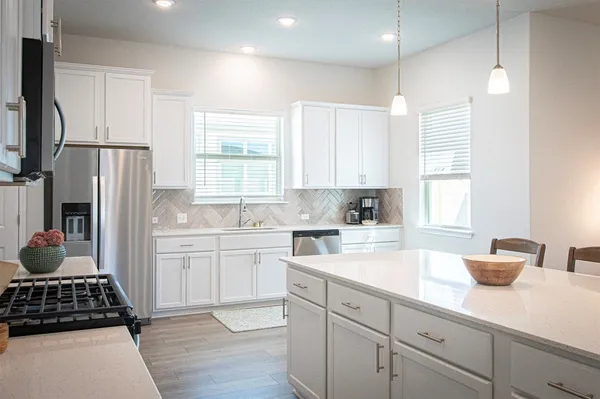 a kitchen with a sink stove and refrigerator