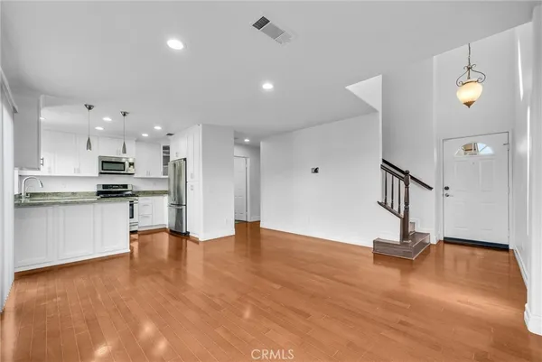 a view of kitchen with stove and wooden floor