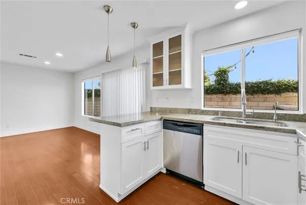 a kitchen with stainless steel appliances granite countertop a stove and a sink