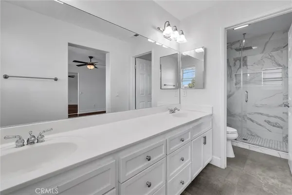 a bathroom with a double vanity sink mirror double and shower