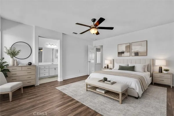 a bedroom with a bed a mirror and a table