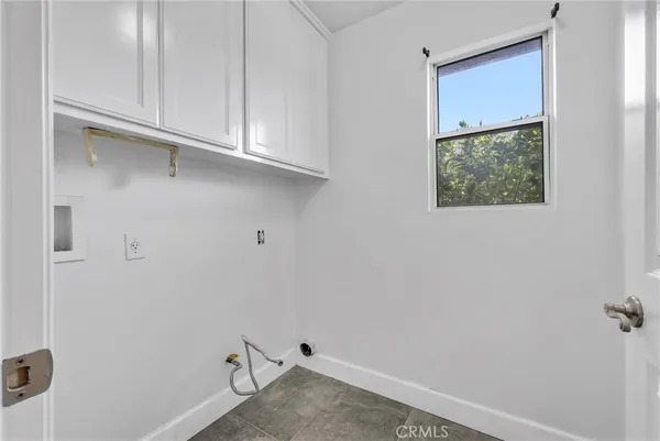 a view of storage and utility room with closet