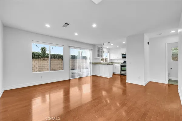 a view of kitchen with wooden floor and a window