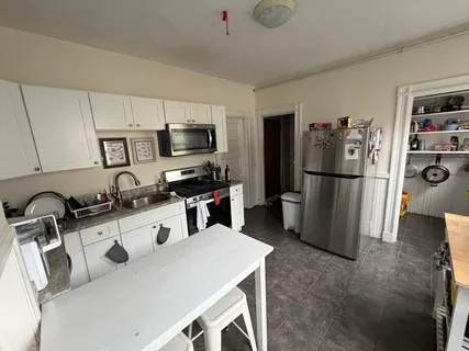 a kitchen with stainless steel appliances a refrigerator stove microwave and sink