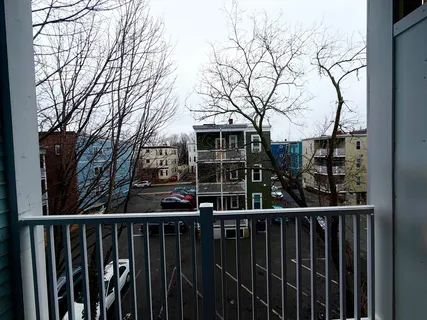 a view of a house with wooden fence