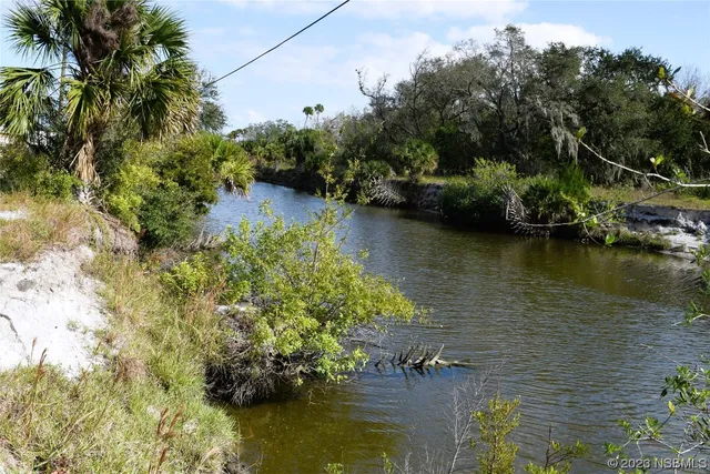 an aerial view of a houses with a lake view