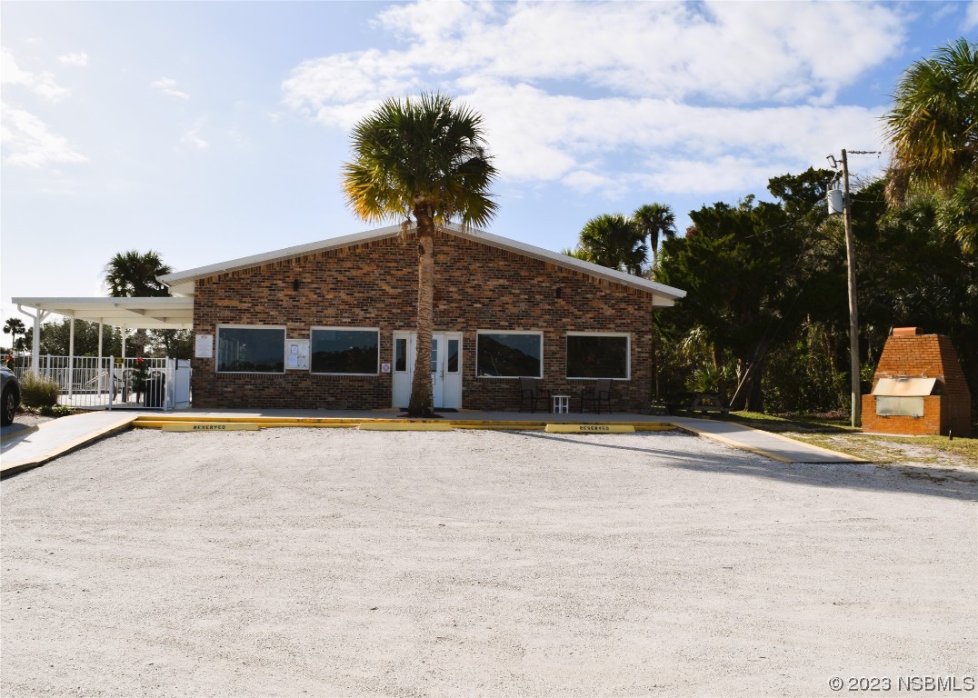 4366 Whiting Way Edgewater, FL 32141 - Photo 10 of 11 a front view of a house with a yard and trees