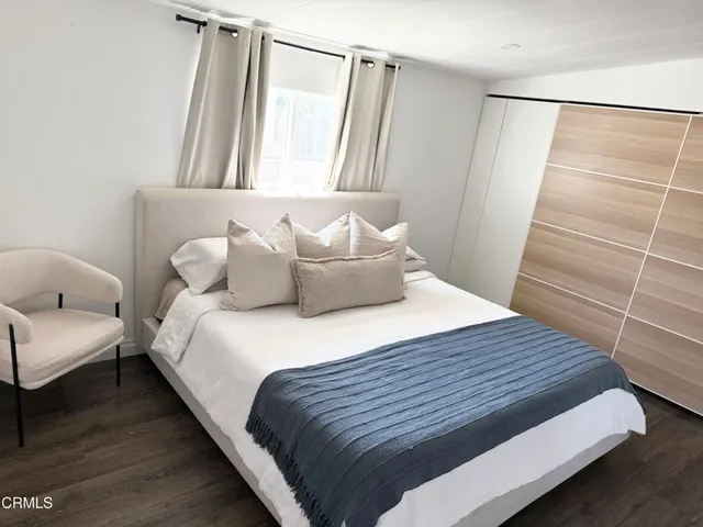 a view of a room with wooden floor and cabinet