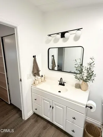 a bathroom with a toilet a sink and a mirror