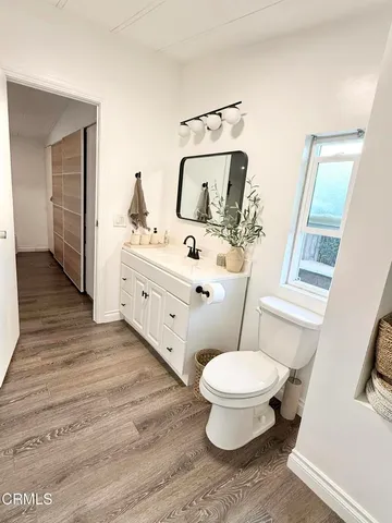 a bathroom with a double vanity sink mirror and toilet