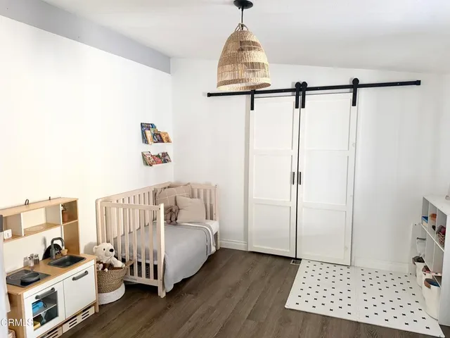 a view of a livingroom with wooden floor and a window