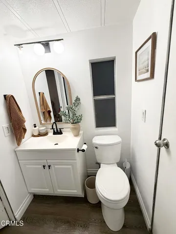 a bathroom with a toilet sink and vanity