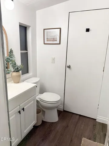 a bathroom with a toilet sink and a mirror