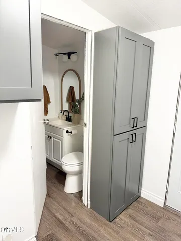 a view of a kitchen with a sink and refrigerator
