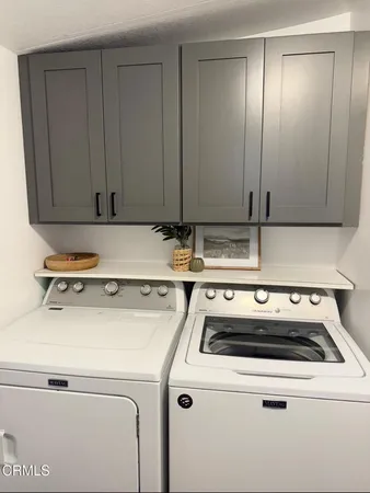 a view of washer and dryer with wooden floor