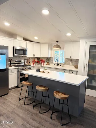a kitchen with a sink cabinets and window