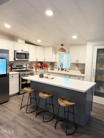 a kitchen with a sink cabinets and window