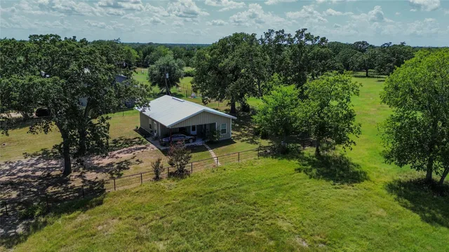 an aerial view of house with yard