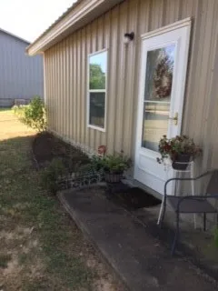 a view of backyard with wooden fence