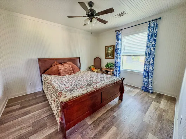 a bathroom with a granite countertop toilet and a sink