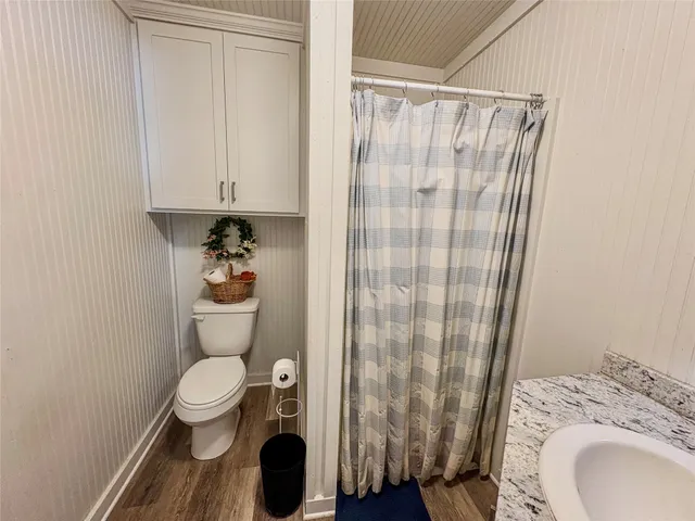a kitchen with a sink cabinets and wooden floor