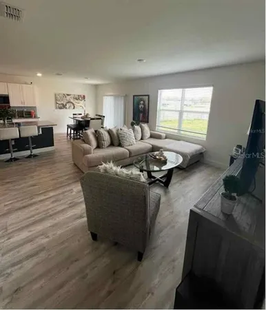 a living room with furniture and a flat screen tv