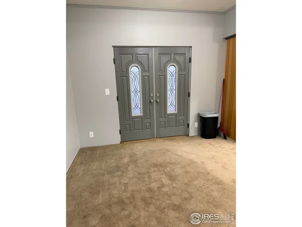 a view of an empty room with closet