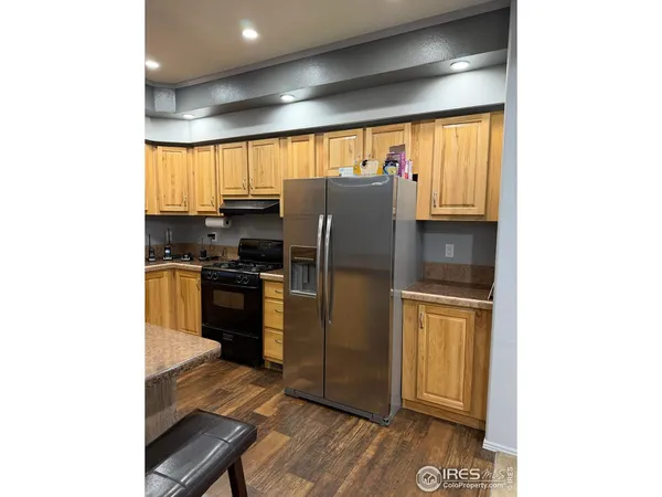 a kitchen with a refrigerator and a stove top oven