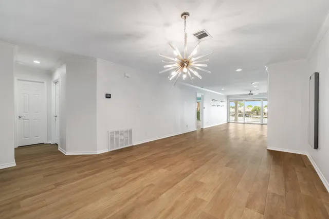 a view of an empty room and wooden floor