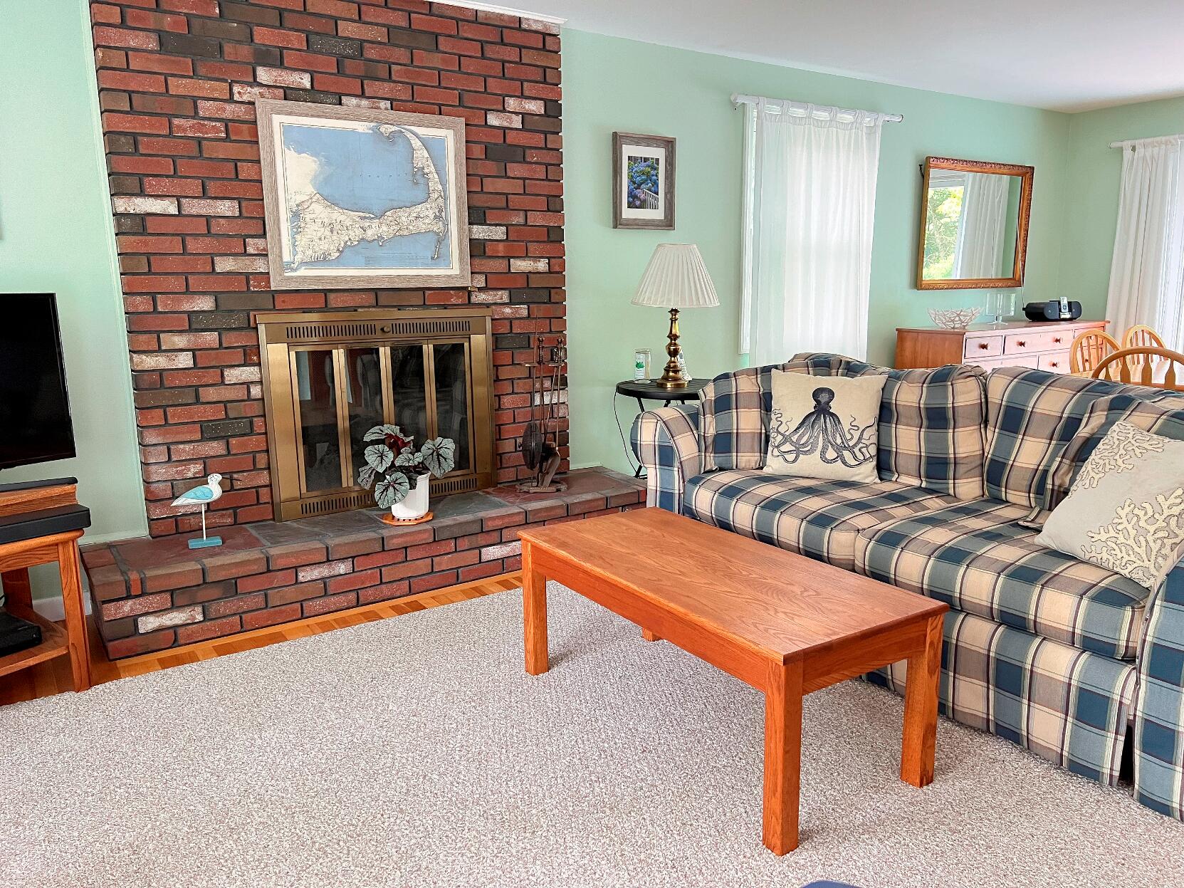 199 Timberlane Drive Brewster, MA 02631 - Photo 19 of 44 a living room with furniture and a fireplace