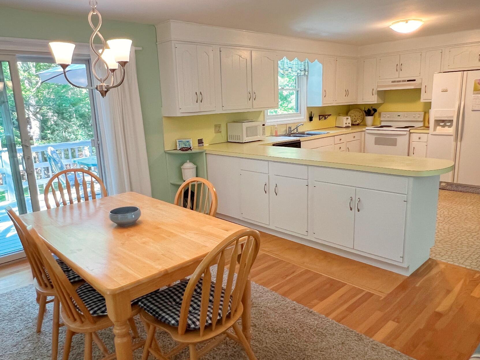 199 Timberlane Drive Brewster, MA 02631 - Photo 21 of 44 a kitchen with stainless steel appliances granite countertop a kitchen island a stove a table and chairs