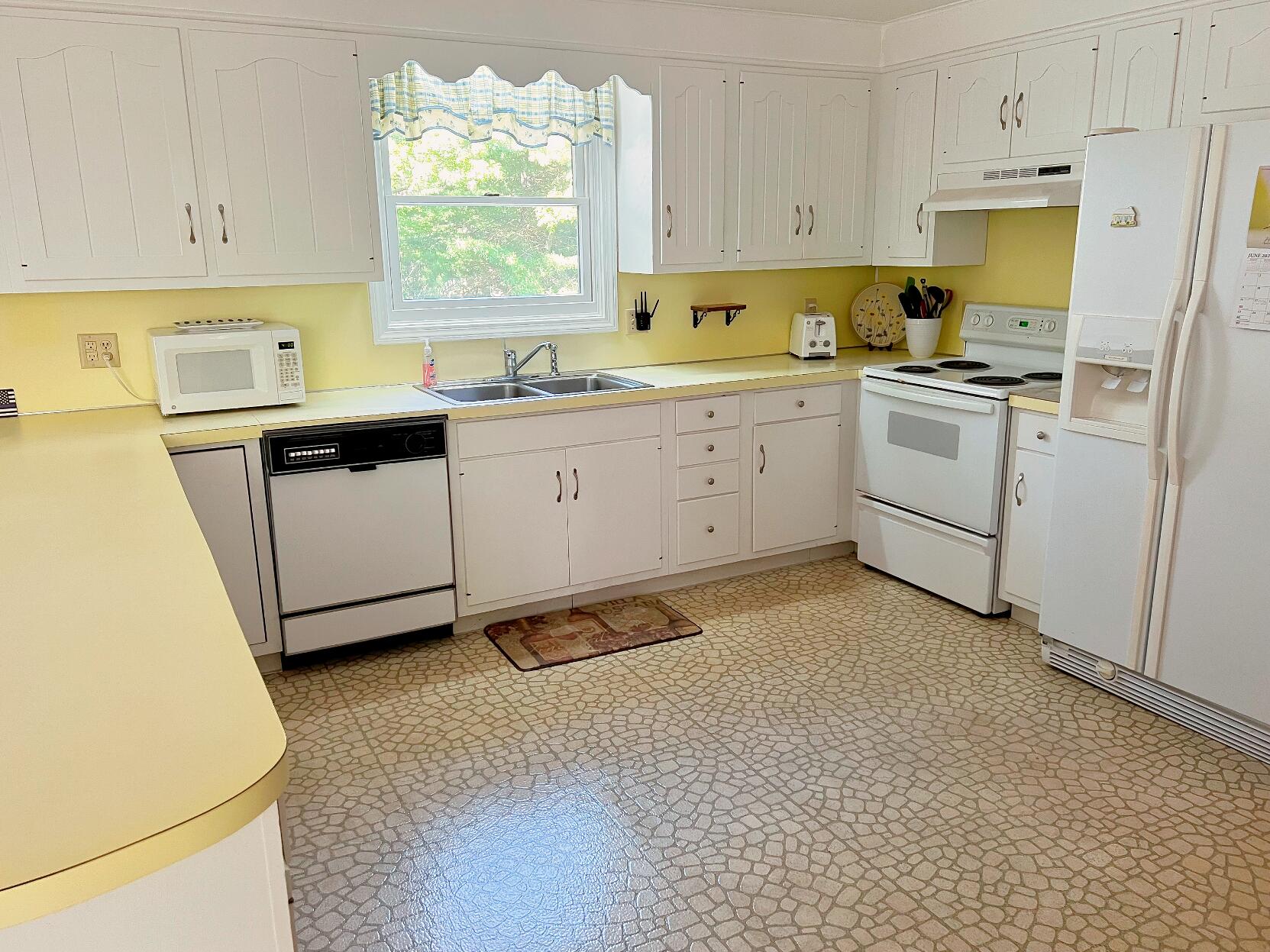199 Timberlane Drive Brewster, MA 02631 - Photo 23 of 44 a kitchen with white cabinets and white appliances