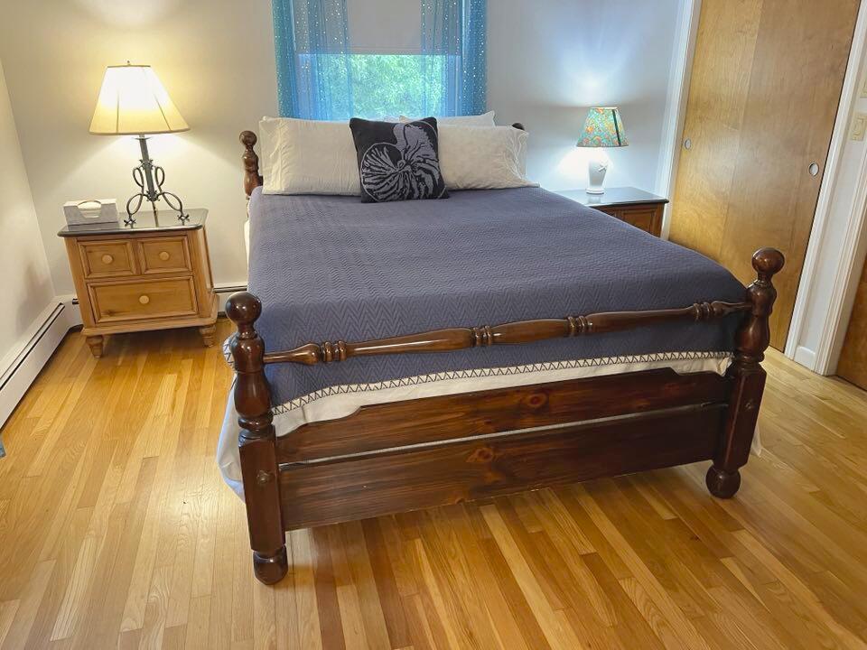 199 Timberlane Drive Brewster, MA 02631 - Photo 25 of 44 a bedroom with a bed and lamps