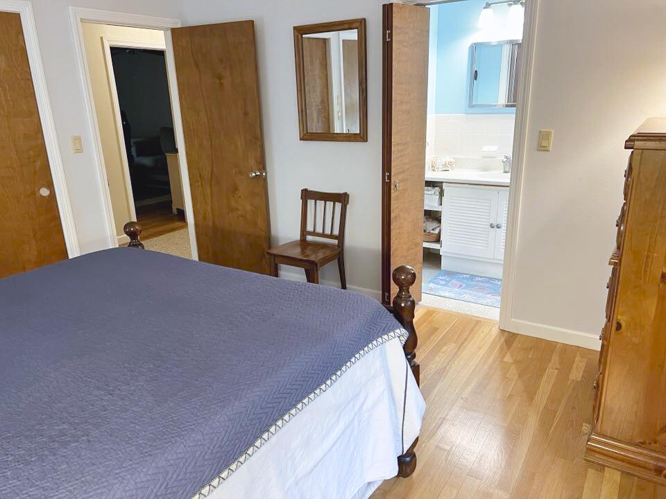 199 Timberlane Drive Brewster, MA 02631 - Photo 26 of 44 a bedroom with a bed and wooden floor