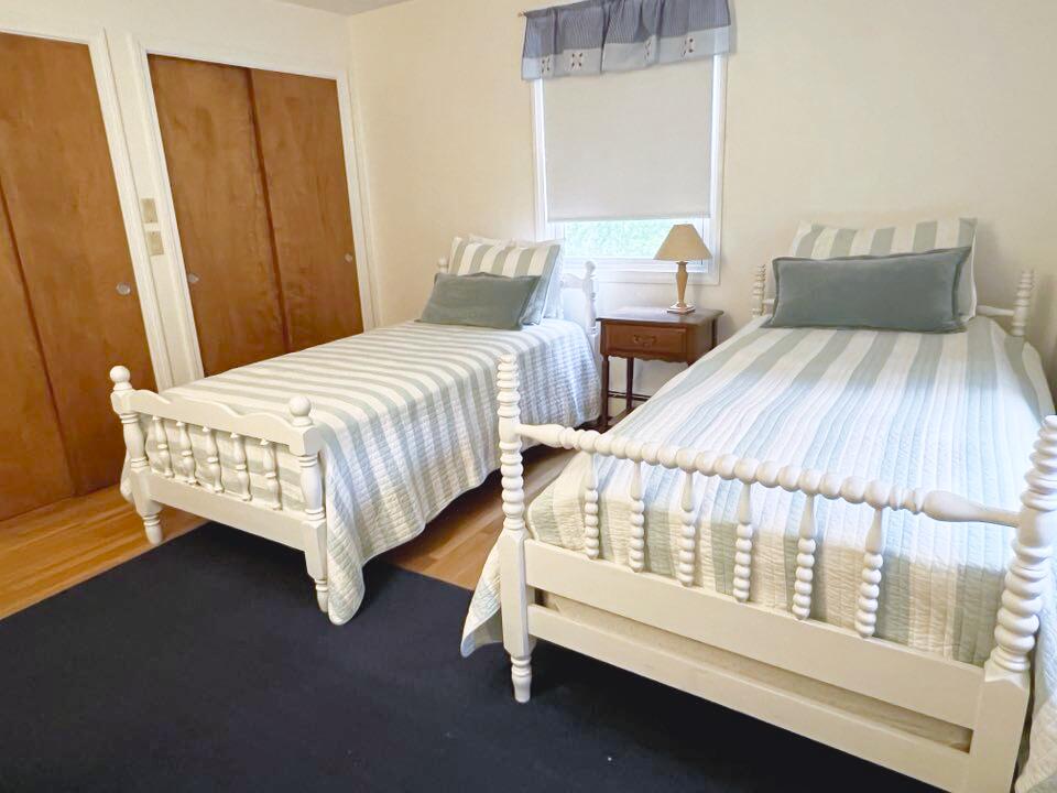 199 Timberlane Drive Brewster, MA 02631 - Photo 30 of 44 a bedroom with two beds and wooden floor