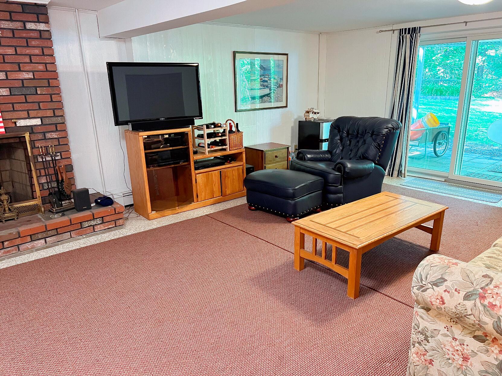 199 Timberlane Drive Brewster, MA 02631 - Photo 37 of 44 a living room with furniture a flat screen tv and floor to ceiling window