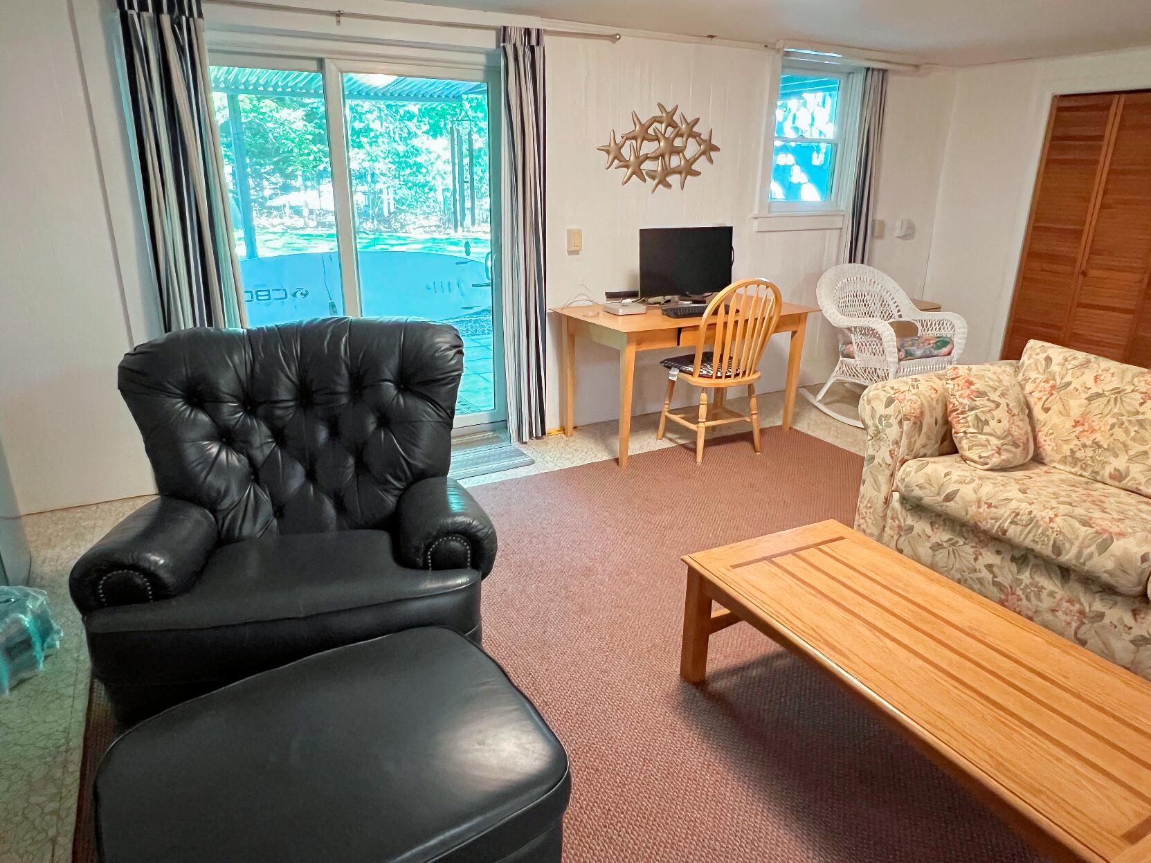 199 Timberlane Drive Brewster, MA 02631 - Photo 38 of 44 a living room with furniture and a fireplace