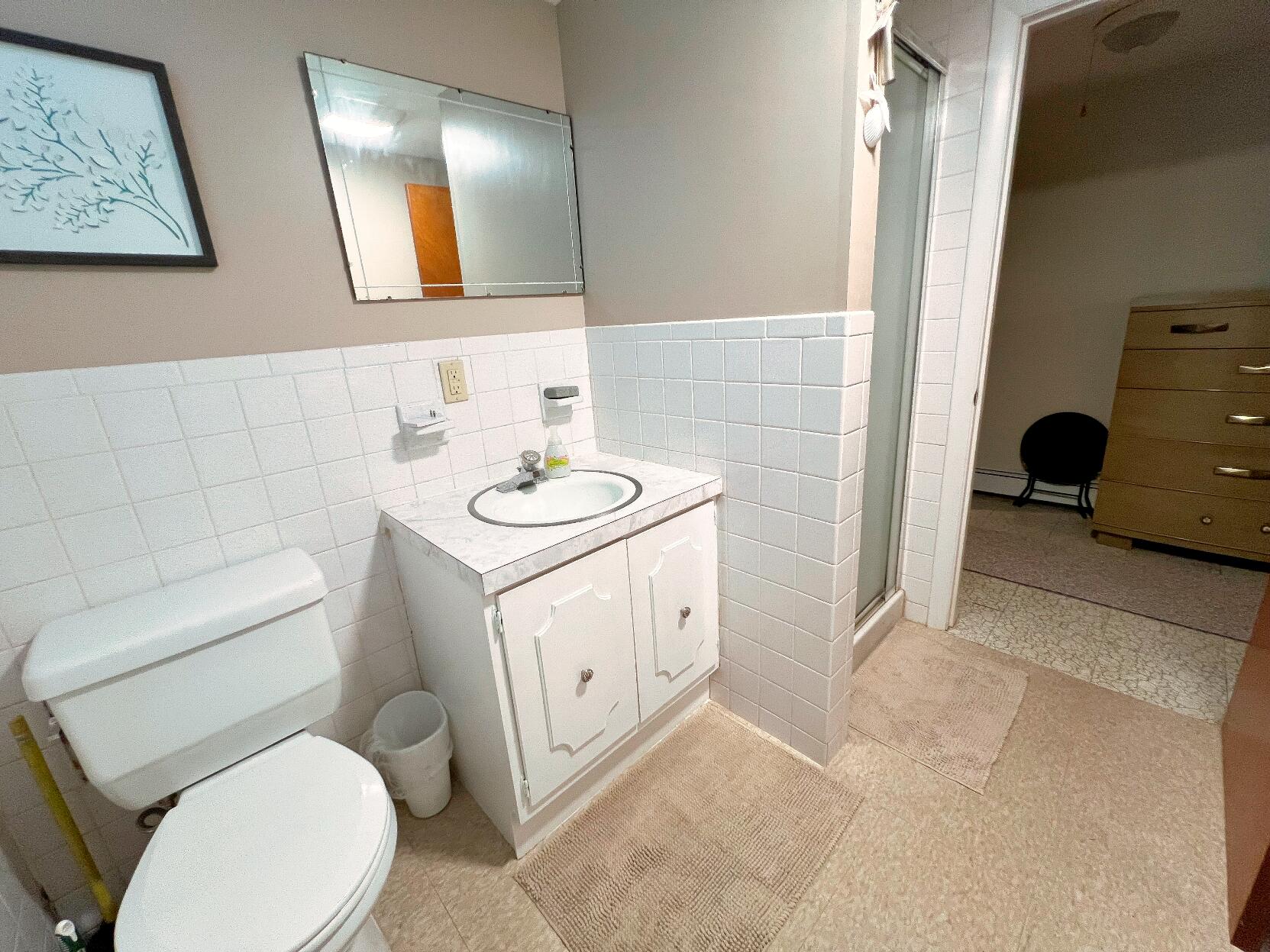 199 Timberlane Drive Brewster, MA 02631 - Photo 40 of 44 a bathroom with a toilet sink and mirror