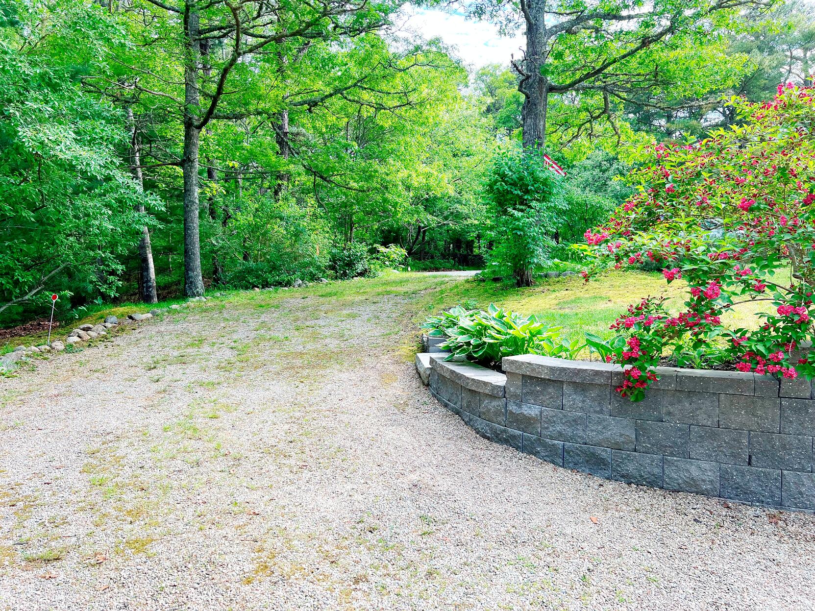 199 Timberlane Drive Brewster, MA 02631 - Photo 4 of 44 a wooden bench sitting in a yard