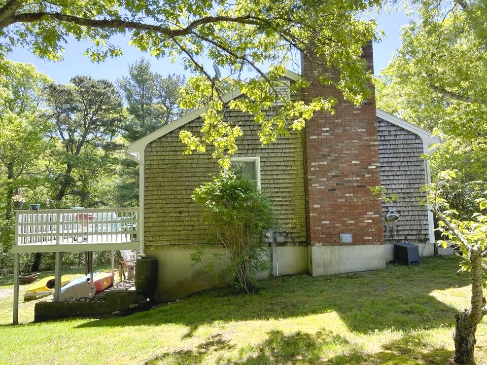 199 Timberlane Drive Brewster, MA 02631 - Photo 7 of 44 a backyard of a house with lots of green space