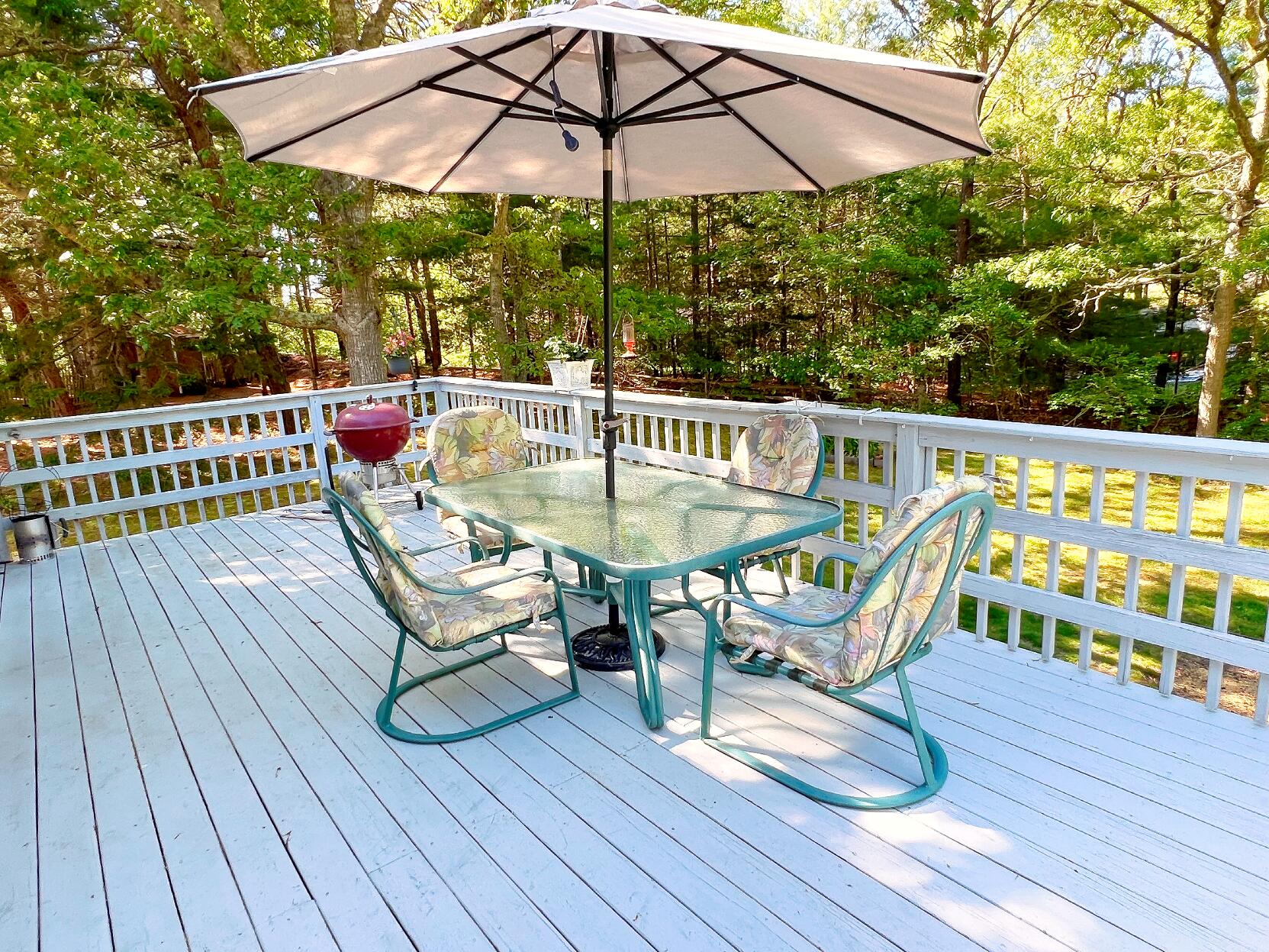199 Timberlane Drive Brewster, MA 02631 - Photo 8 of 44 a view of a chairs in wooden deck