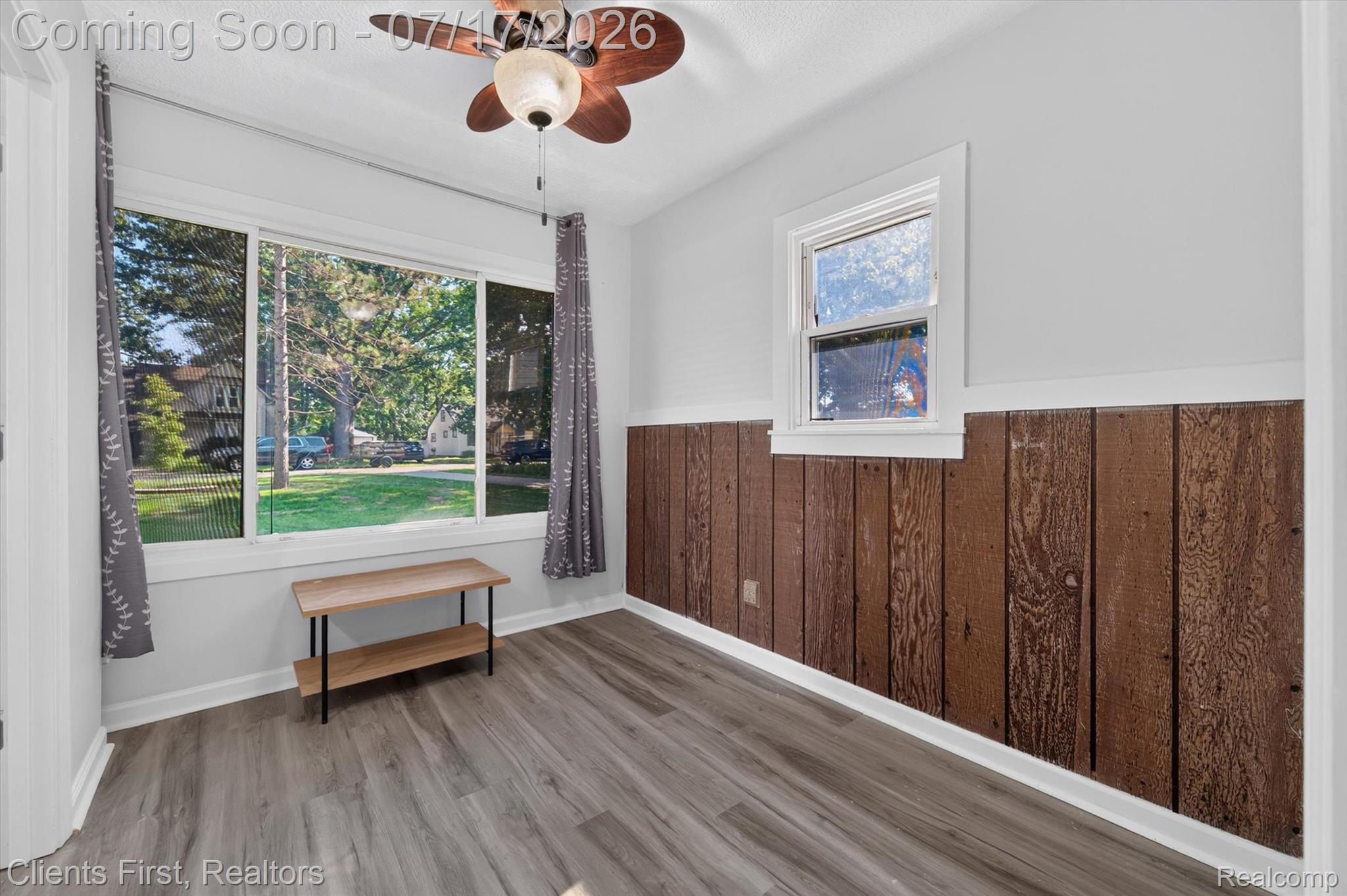 36852 Chase Street Romulus, MI 48174 - Photo 25 of 40 Room featuring wood-finish plank flooring and light gray walls with a lower wood panel wainscoting