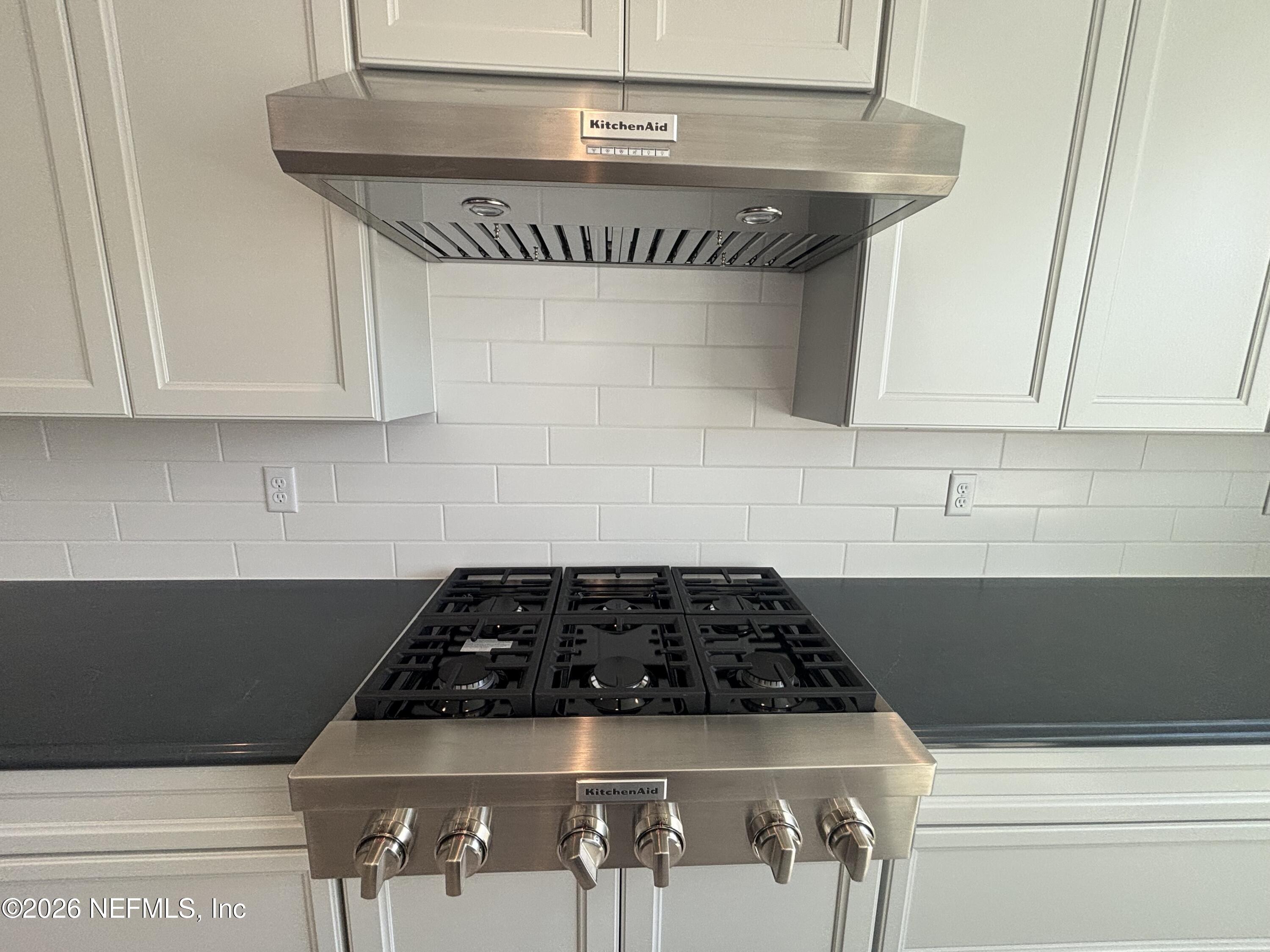 74 Sapling Terrace St. Johns, FL 32259 - Photo 15 of 39 a kitchen with a stove a microwave and cabinets