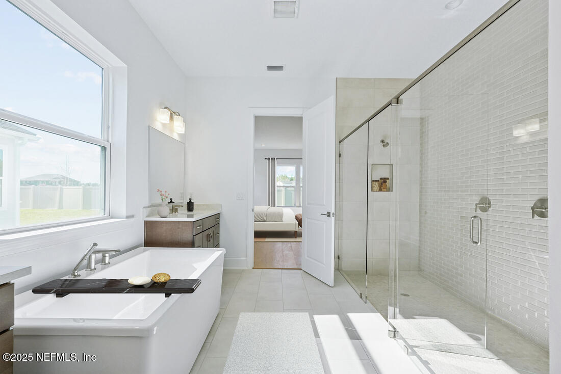 74 Sapling Terrace St. Johns, FL 32259 - Photo 28 of 39 a spacious bathroom with a double vanity sink and a mirror